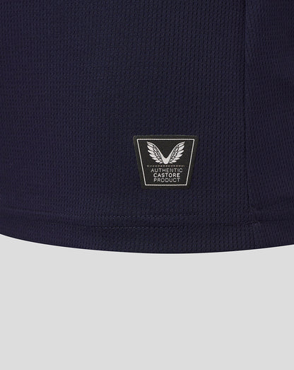 Close-up of navy fabric showing Authentic Castore Product badge with a winged emblem near the lower back