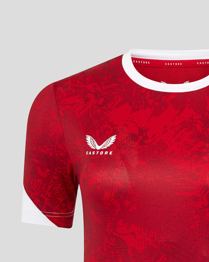 Red away match shirt with white crew neck collar and abstract print, Castore logo on the chest and Athletic Club crest on the opposite chest