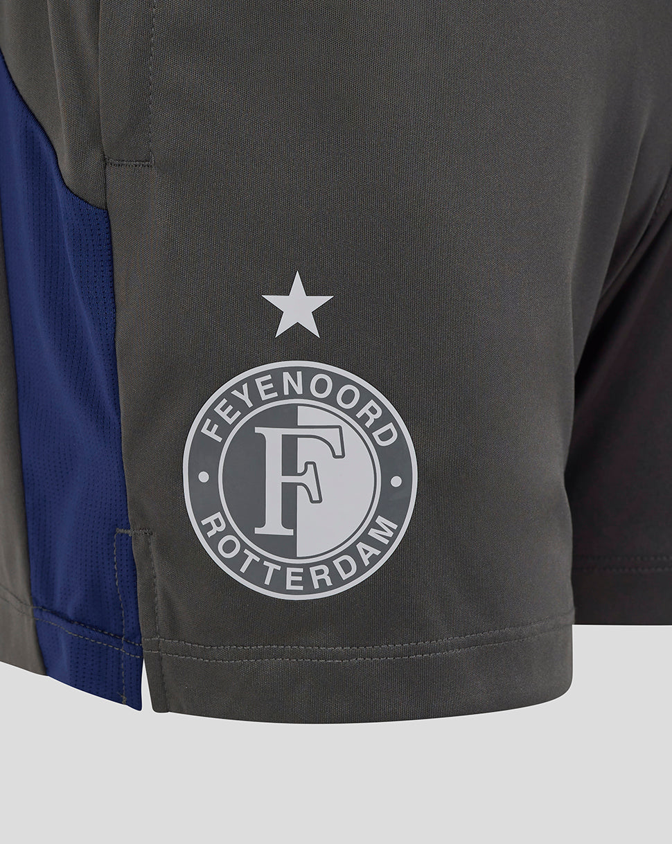 Close-up of a dark gray athletic shorts leg featuring a circular Feyenoord Rotterdam logo in white and a blue side panel.