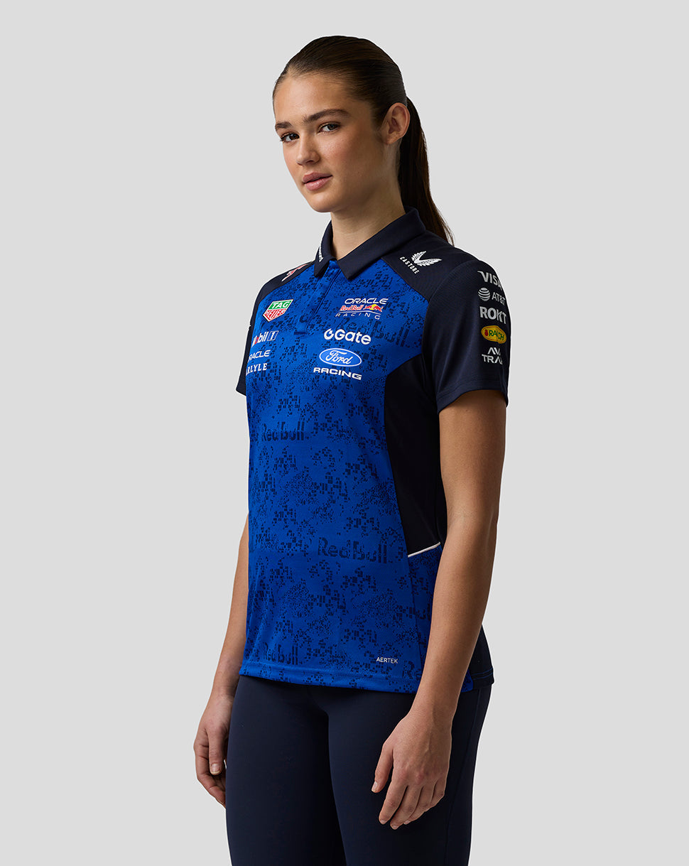 Person wearing a blue and black sports jersey with various sponsor logos on a white background