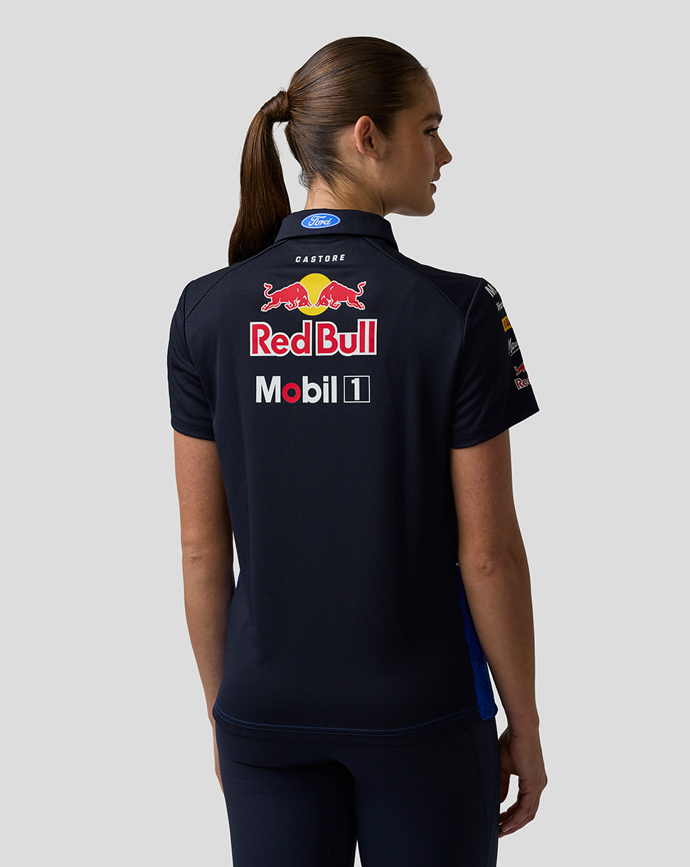 Person wearing a black polo shirt with Red Bull and Mobil 1 logos on the back.