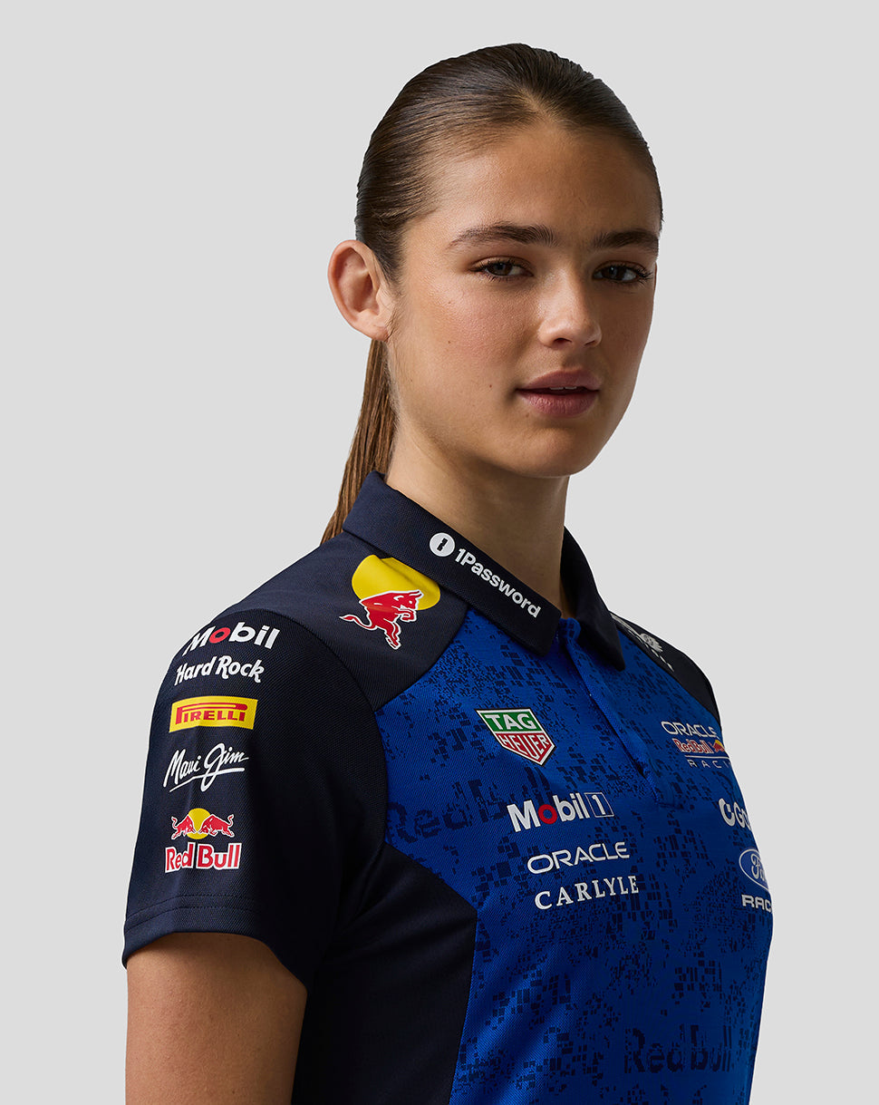 Person wearing a blue racing shirt with various sponsor logos on a gray background