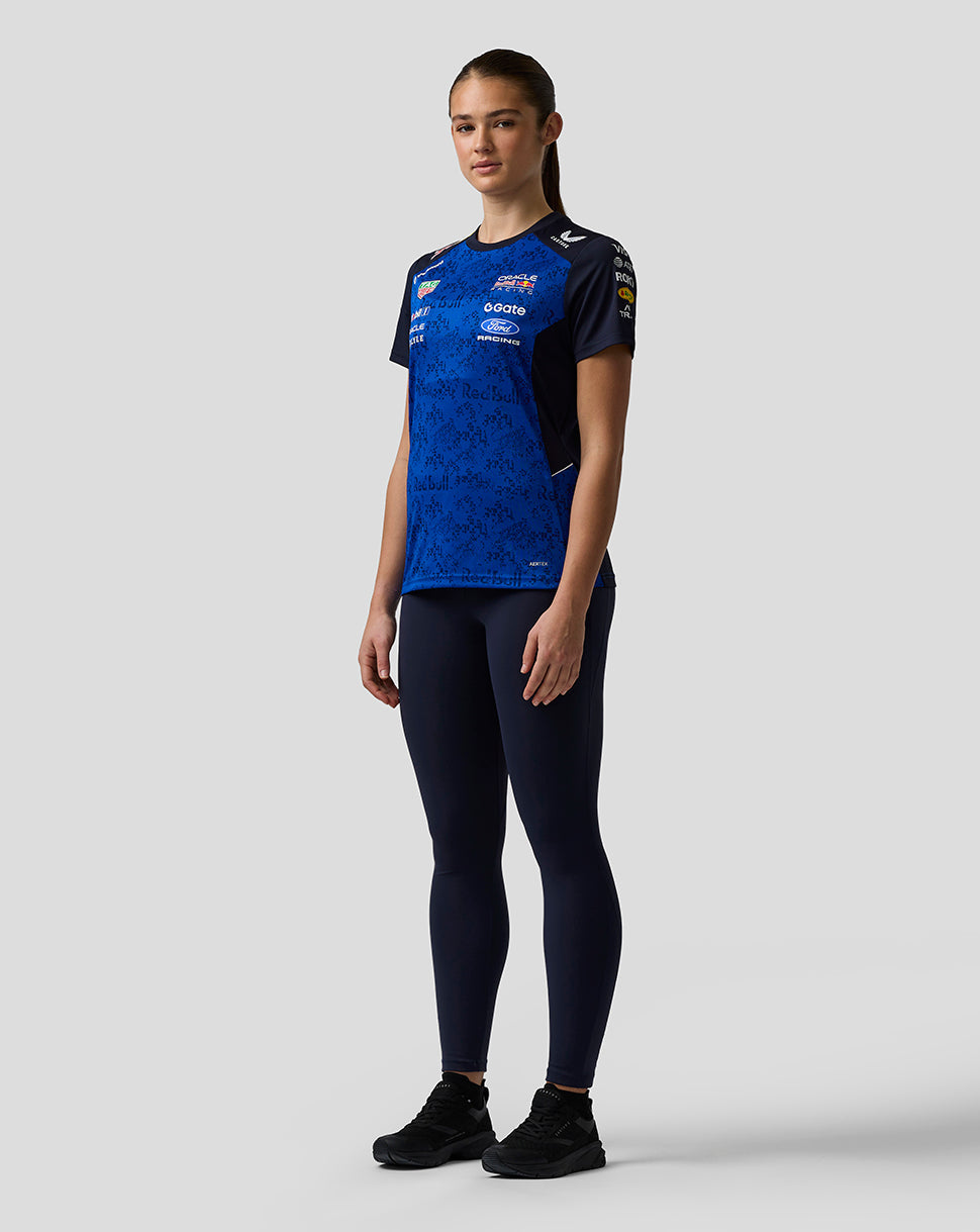 Person wearing a blue sports outfit with visible branding on a white background