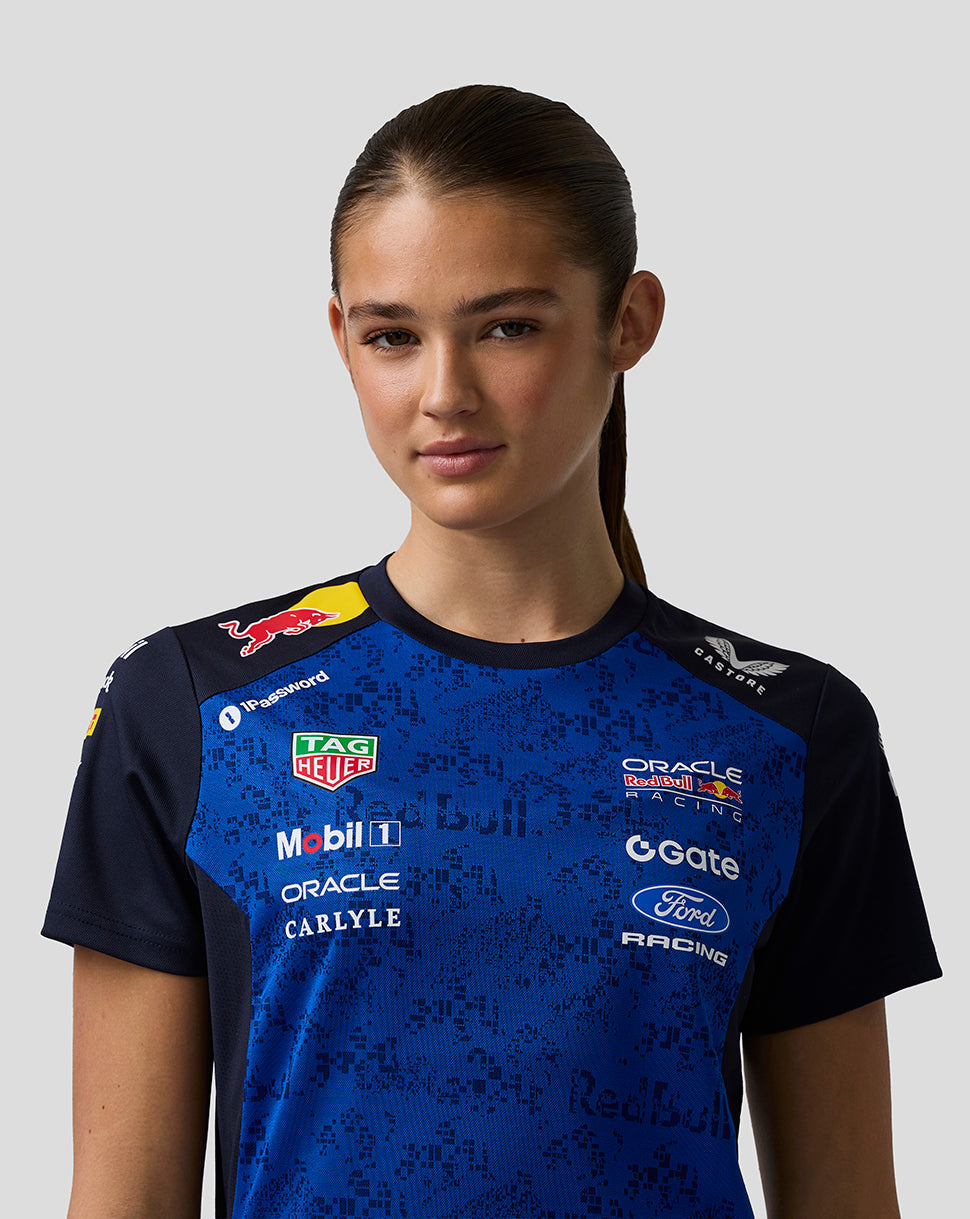 Person wearing a blue and black sports jersey with various sponsor logos on a gray background