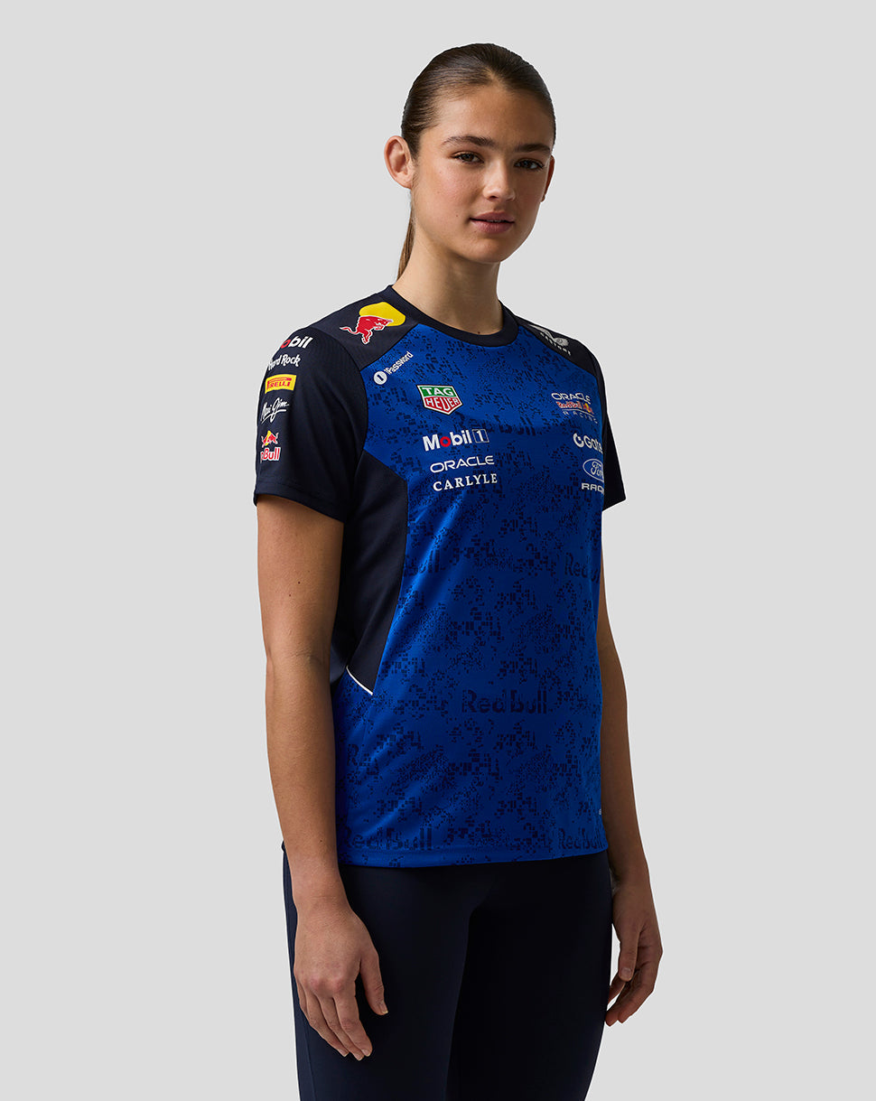 Person wearing a blue and black sports jersey with various sponsor logos on a gray background