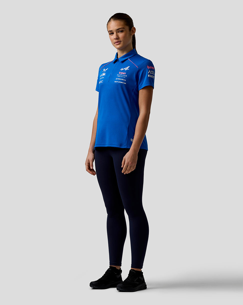 Model wearing blue Official Women’s BWT Alpine Formula One Team Polo Shirt in a studio