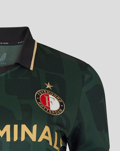 Close-up of Feyenoord crest with gold star above on dark green Twelfth Shirt and bold gold sponsor lettering across the chest.