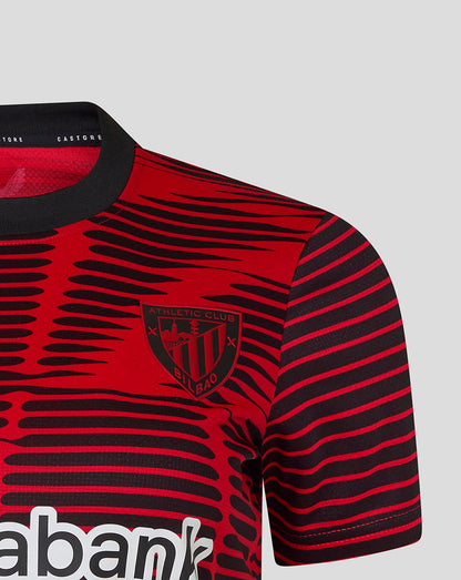Close up of red and black striped Athletic Club shirt showing crest on the left chest.