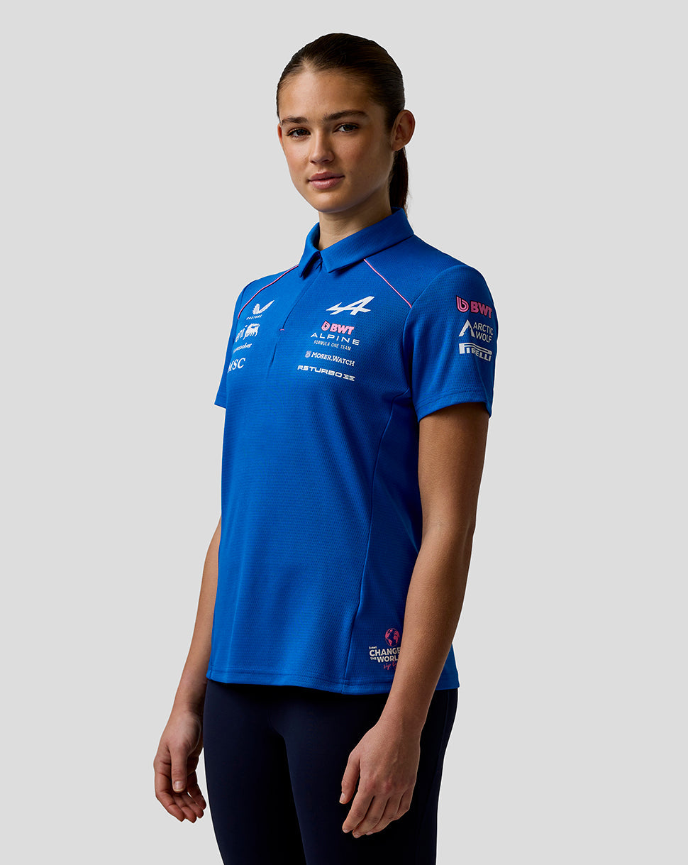 Three-quarter view of a woman in a blue BWT Alpine polo with team logos and concealed zip