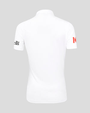 White polo shirt with branding on sleeves against a gray background
