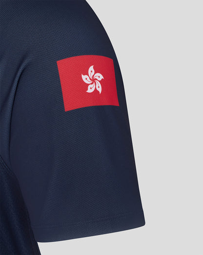 Navy blue shirt with a red and white emblem on the sleeve against a light gray background