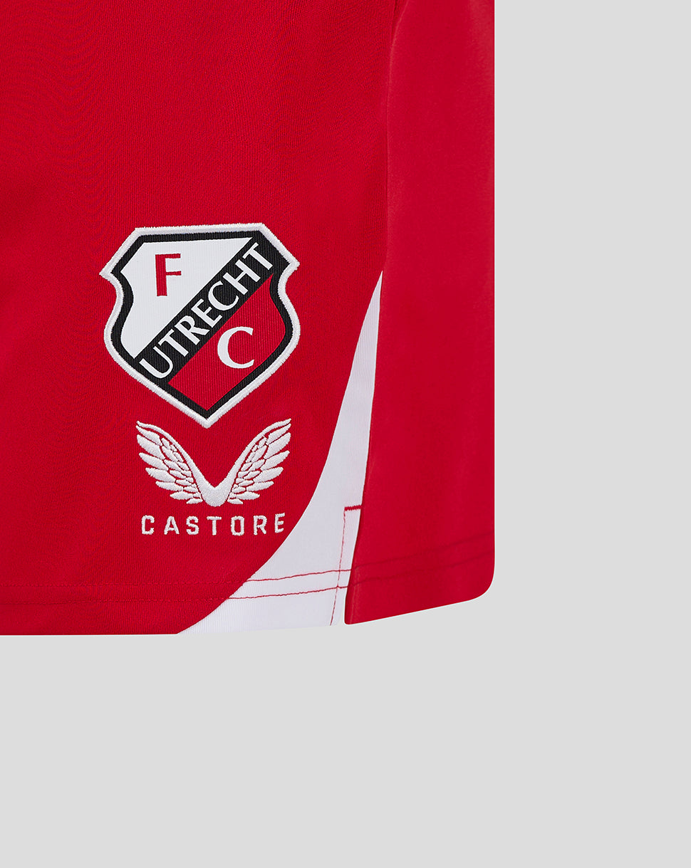 Close-up of the FC Utrecht crest on red shorts with a white diagonal panel