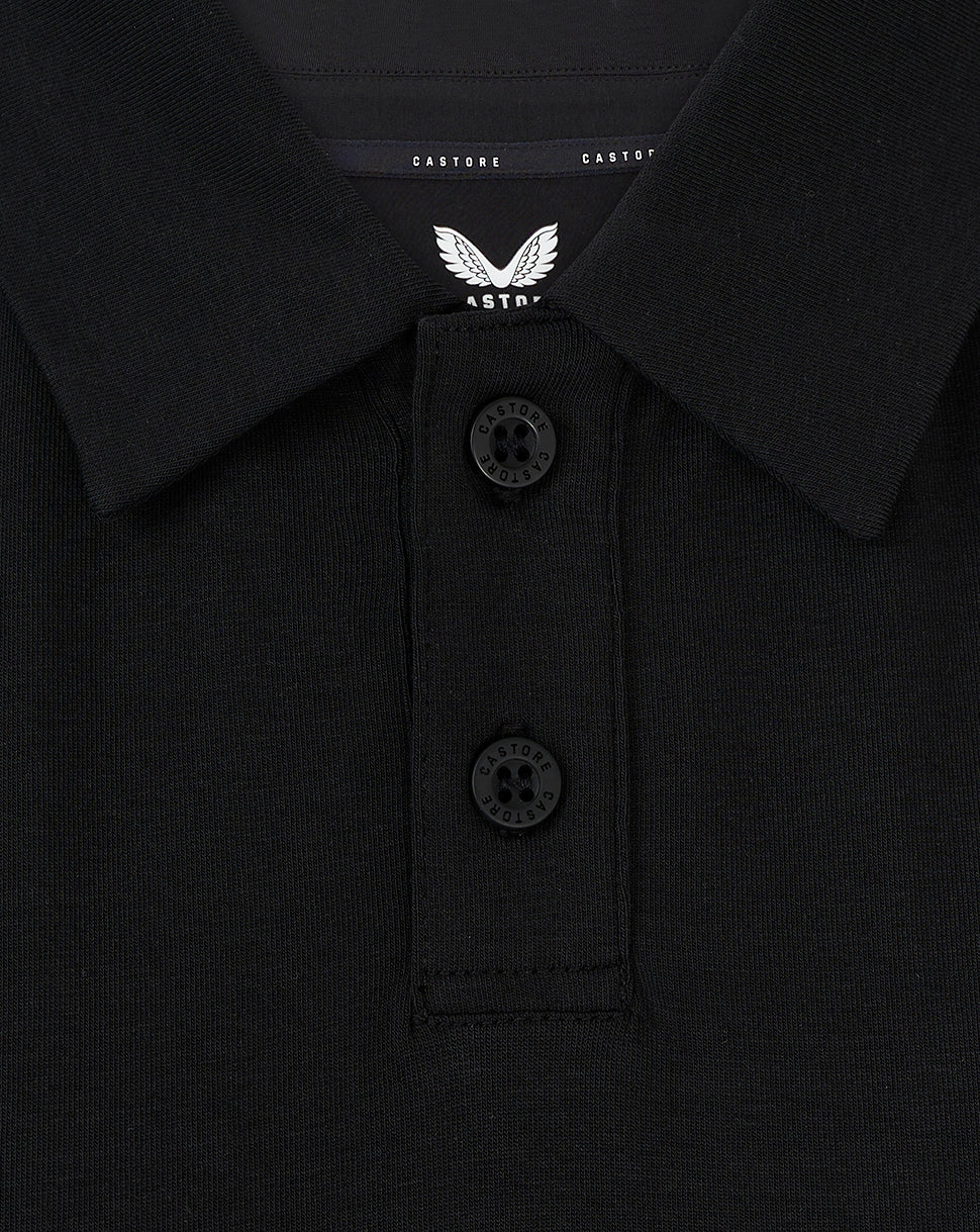 Close-up of black FC Twente Travel Polo collar with a two-button placket and Castore wings branding on the chest
