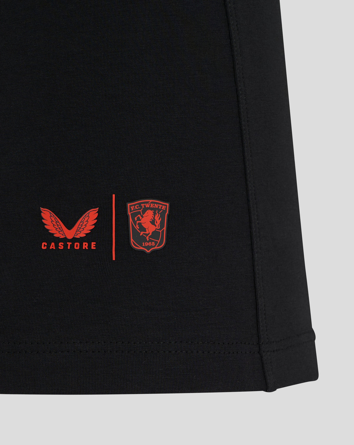 Chest view of black FC Twente Travel Polo showing the FC Twente crest and Castore branding