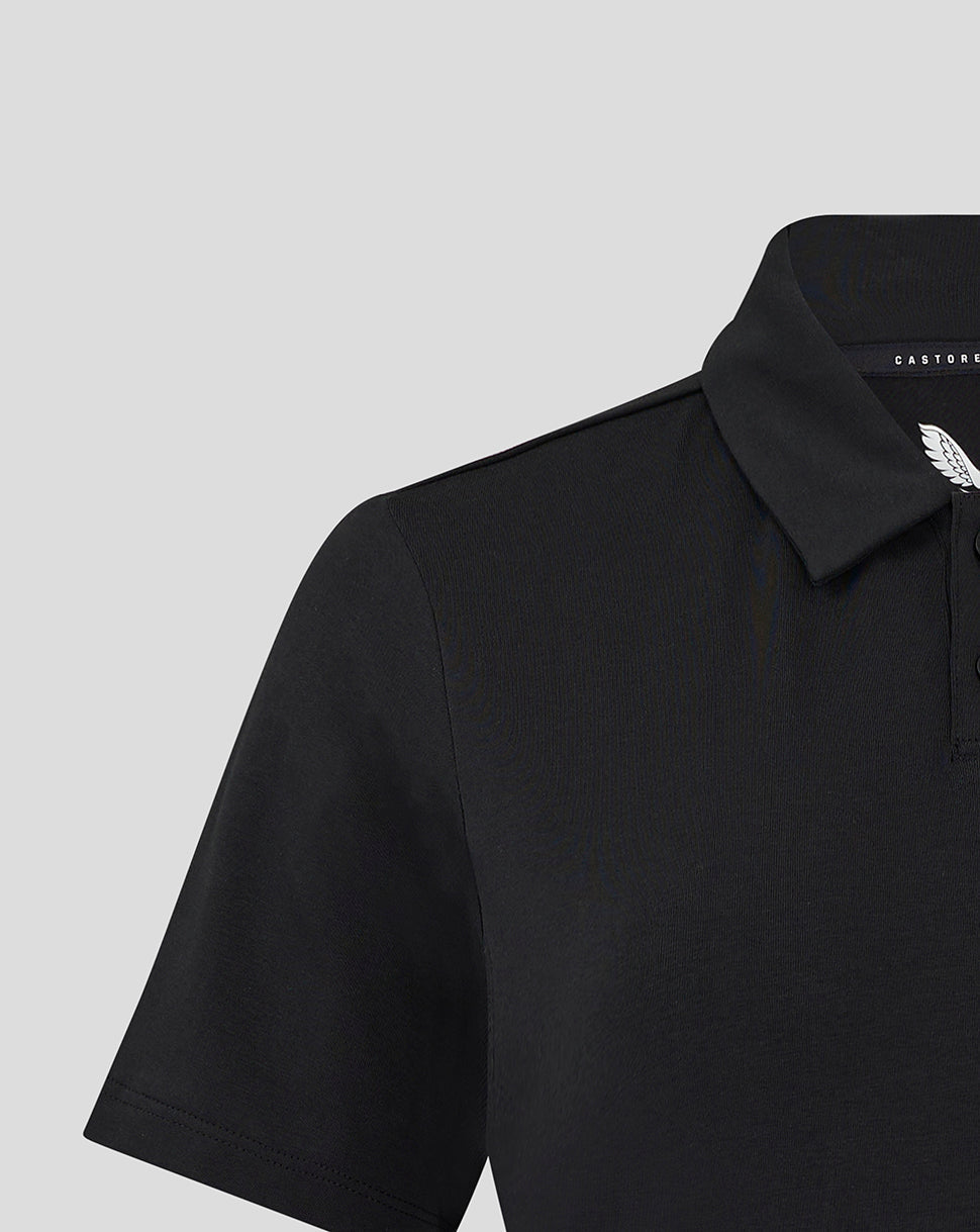 Close-up of black Travel Polo collar with Castore branding and white wing emblem on the chest