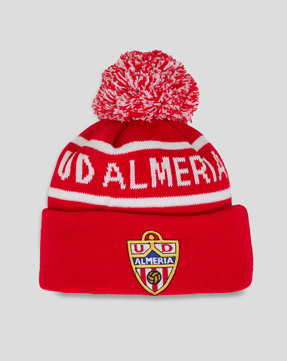 Red Almeria Junior bobble hat with white stripes, fluffy red and white pom pom, and crest on the cuff.