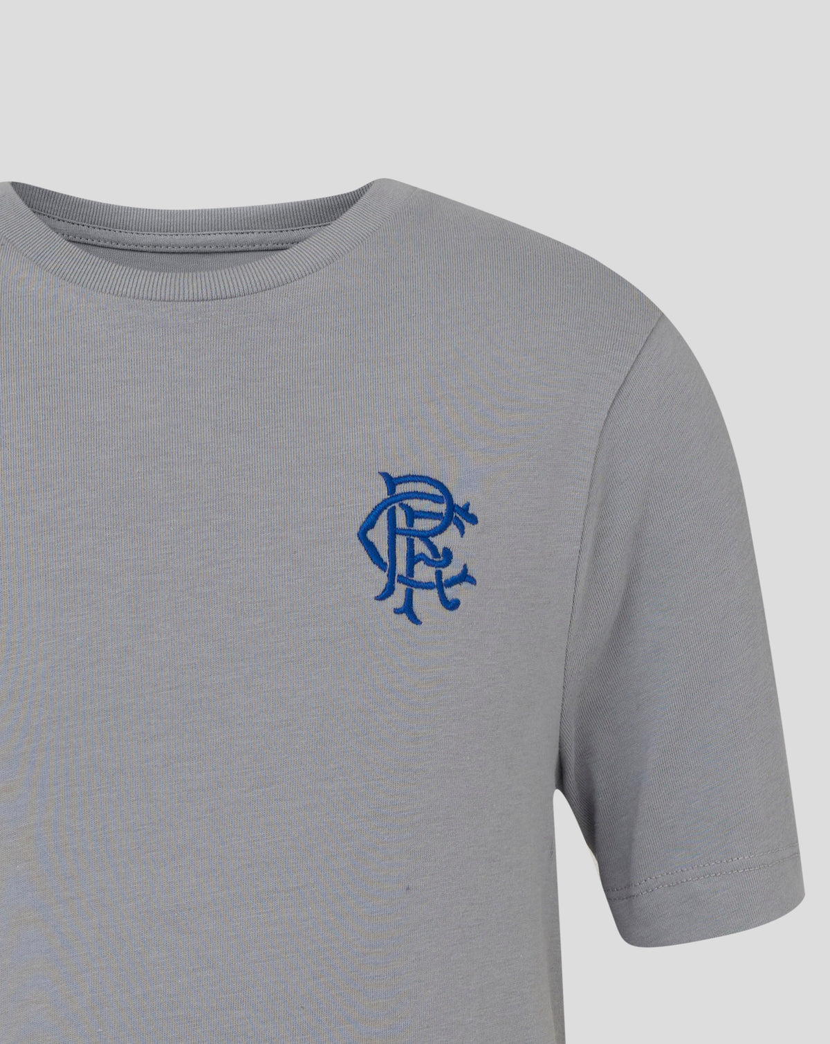 Close-up of a light grey Rangers Junior Core Crest Tee with a blue embroidered crest on the left chest.