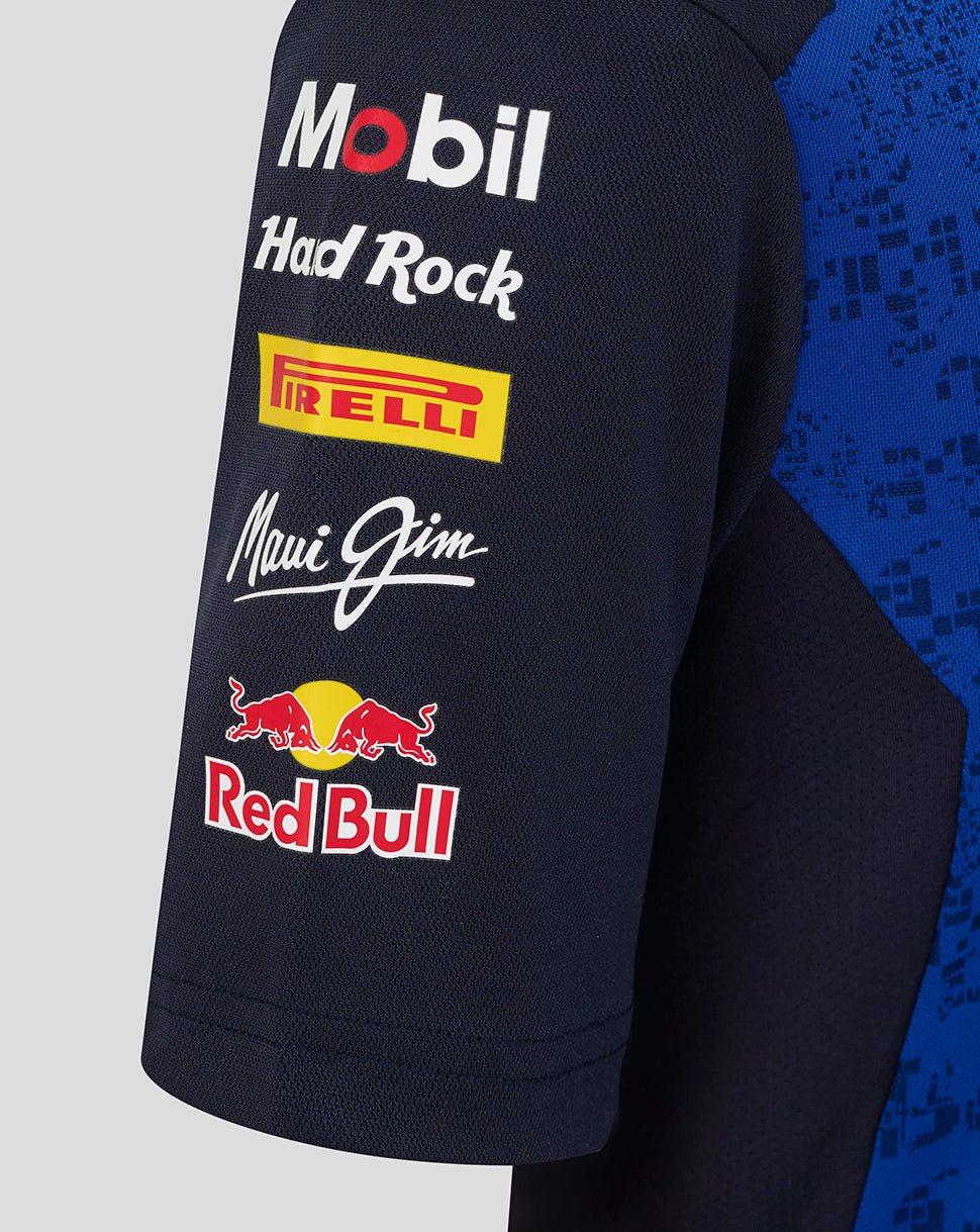 Navy blue jacket with various brand logos on a gray and blue gradient background
