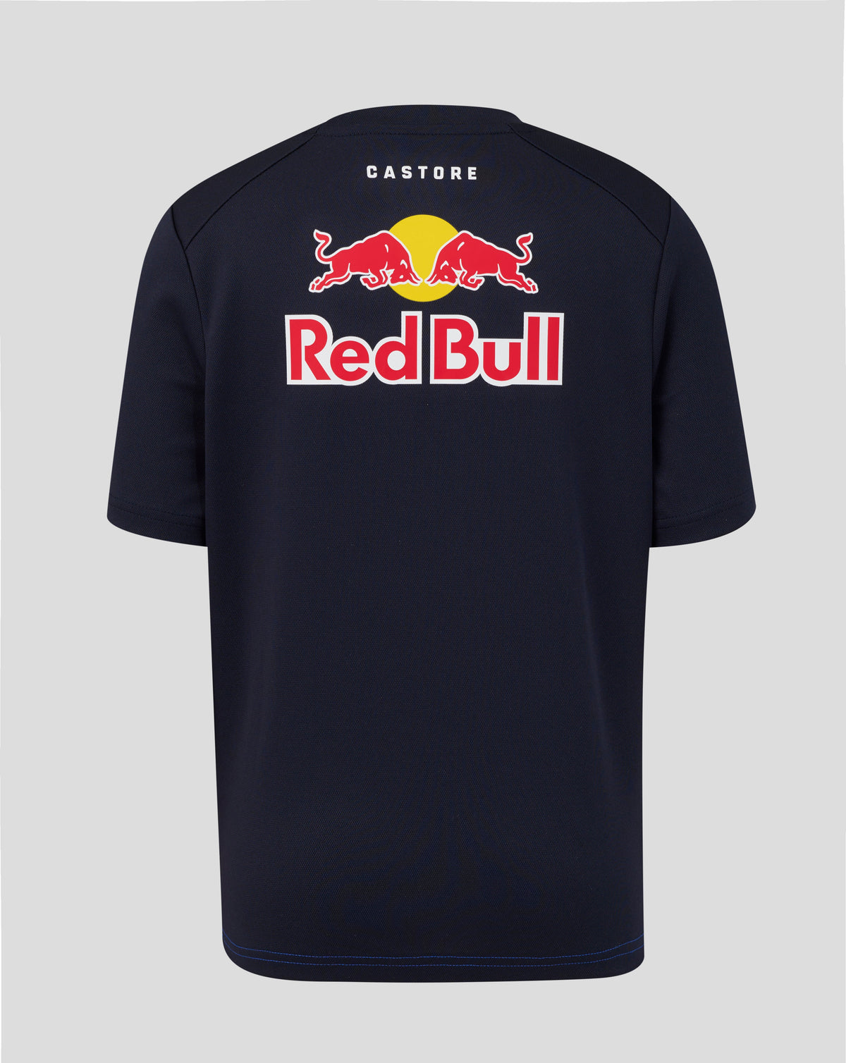 A navy blue Castore Red Bull t-shirt shown from the back, featuring the iconic red bull logo and 'Red Bull' text with a yellow sun graphic.