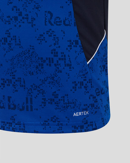 Close-up of a blue athletic garment with a tonal dark blue pixelated pattern, a dark navy side panel, a thin white piping accent, and the word AERTEK near the hem.