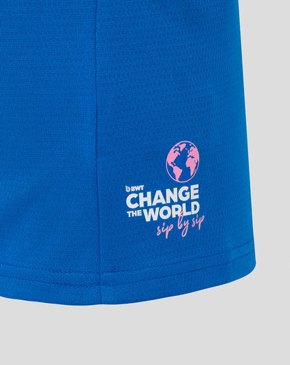 Close up of blue BWT Alpine Set Up T shirt hem with pink globe logo and Change the World sip by sip text
