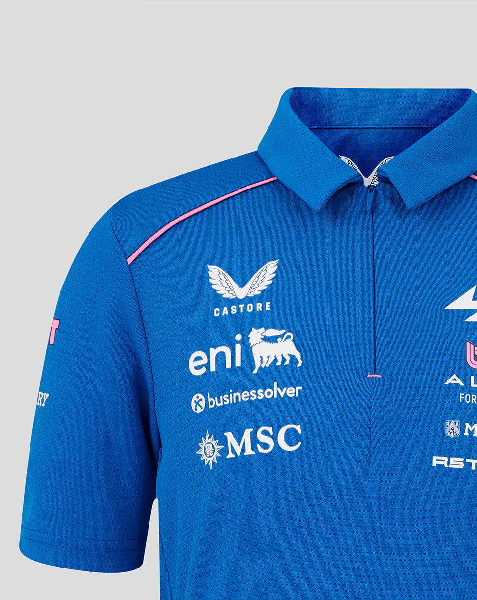 Front view of blue junior BWT Alpine polo with chest sponsor logos and pink shoulder piping.