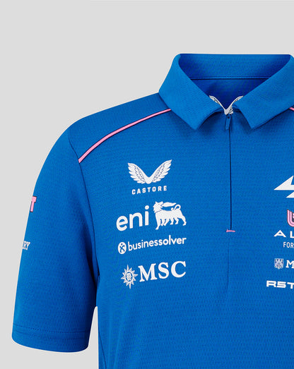 Front view of blue junior BWT Alpine polo with chest sponsor logos and pink shoulder piping.