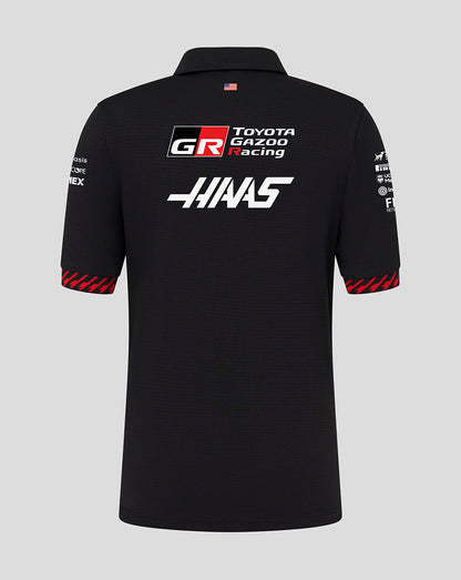 Black polo shirt with Toyota Gazoo Racing and Haas logos on a gray background