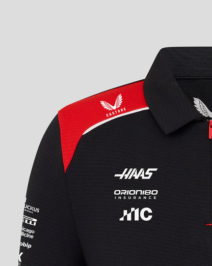 Black polo shirt with red accents and multiple brand logos on a gray background