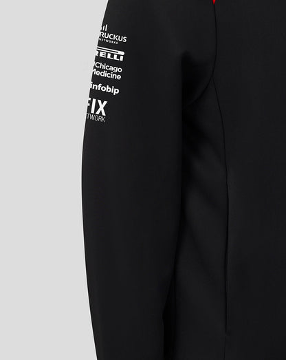 Black jacket with white text logos on a gray background