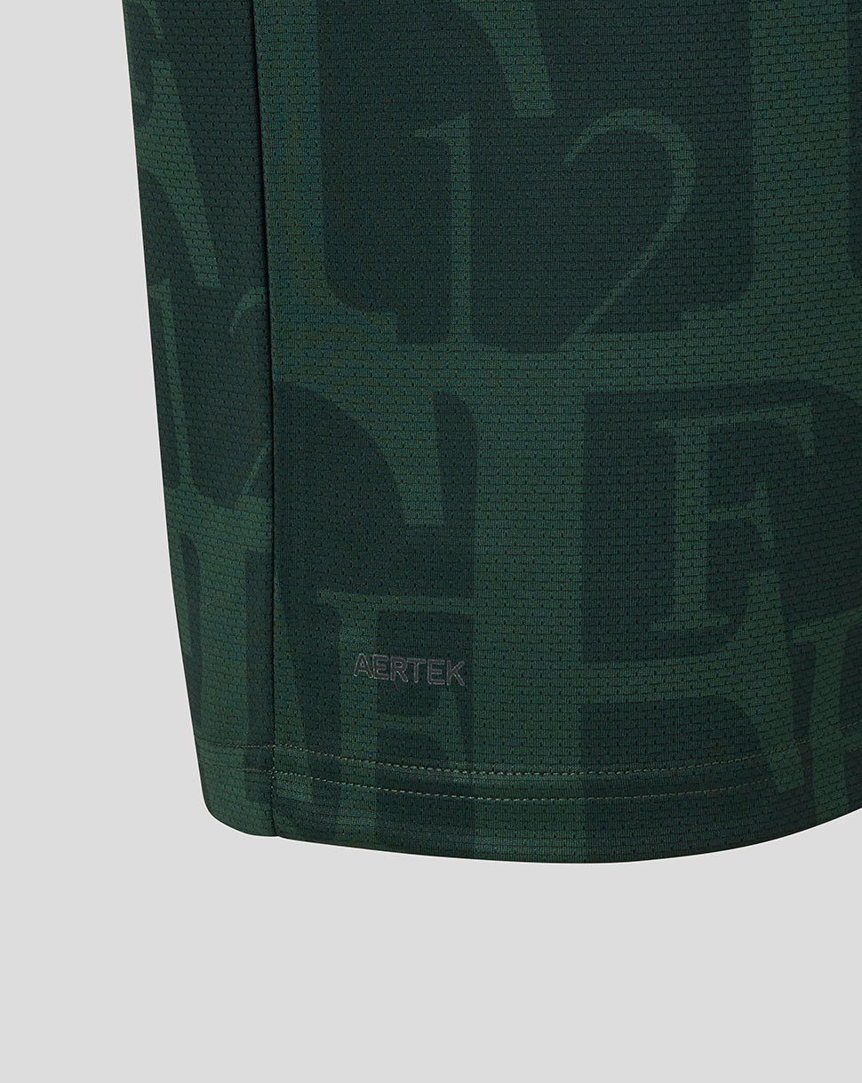 Close-up of dark green Twelfth Shirt fabric with AERTEK label at the hem