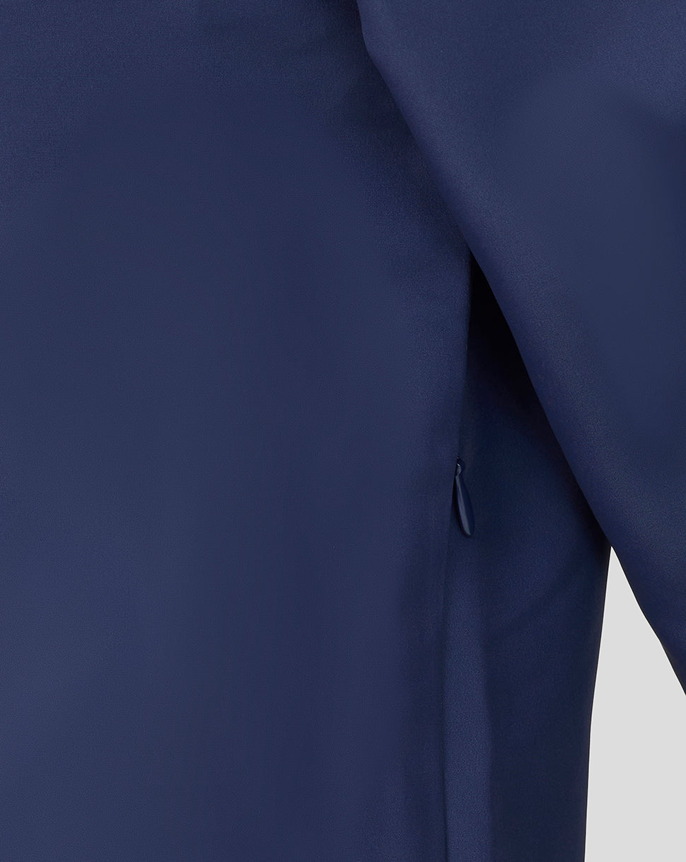 Close-up of a navy blue garment with a zipper on a light gray background