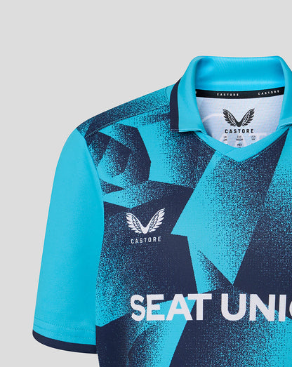 Blue and black sports jersey with 'Castore' branding on a light gray background
