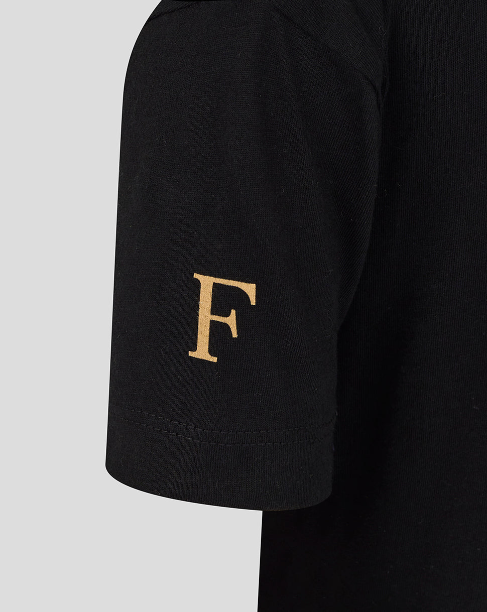 Gold letter F on the sleeve of the black Feyenoord Junior shirt