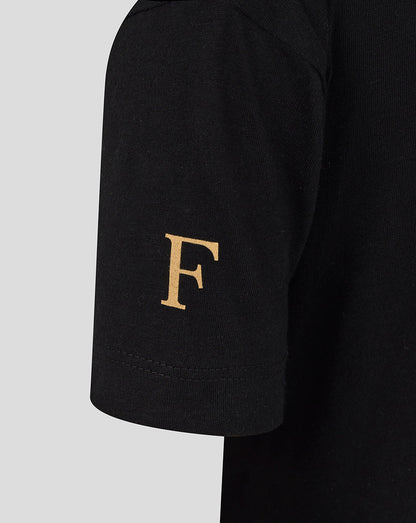 Gold letter F on the sleeve of the black Feyenoord Junior shirt
