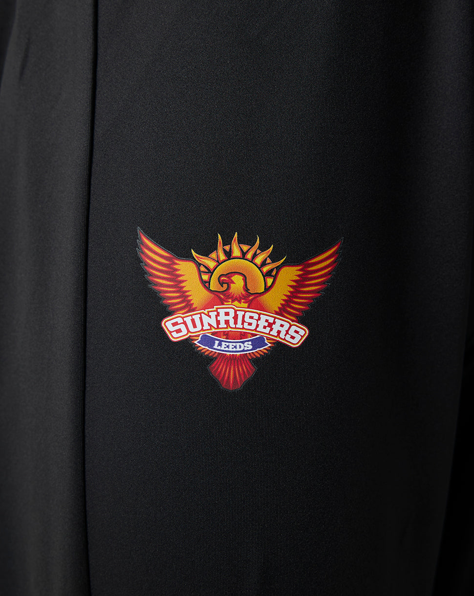 Close-up of the Sunrisers Leeds logo on black fabric of juniors pants