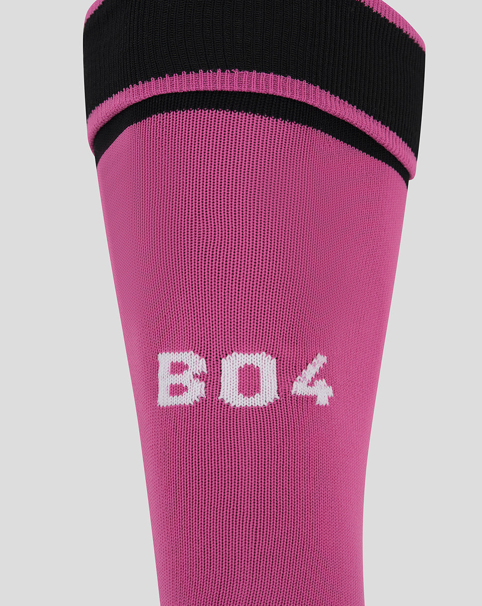 A close-up of a pink athletic sock with a black ribbed cuff, featuring the white knit text 'B04' on the front, set against a solid light gray background.