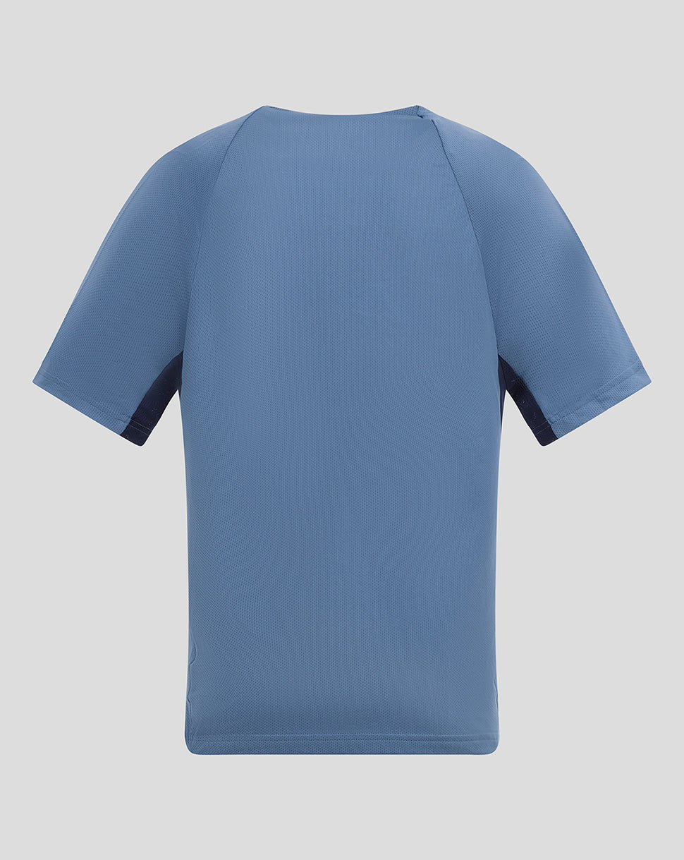 Back view of the light blue Sevilla junior training shirt showing plain rear design