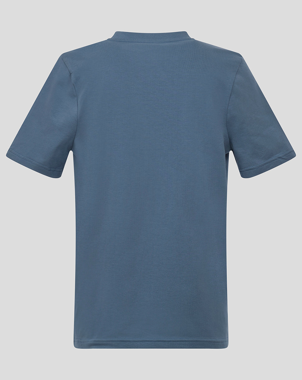 Back view of blue Almeria junior logo shirt showing solid back and short sleeves.
