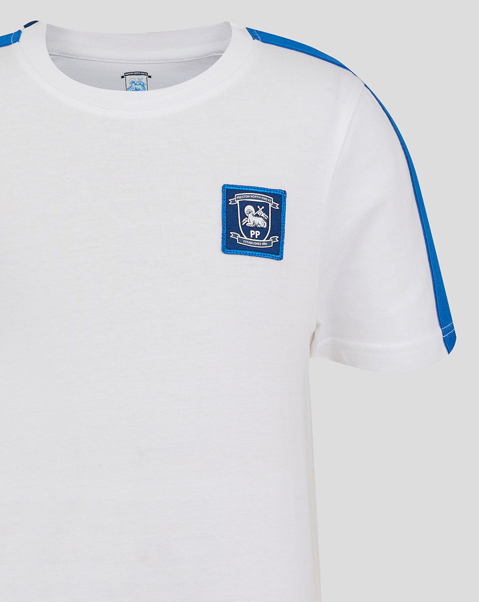 Close-up of white Junior 24/25 Classic Cotton T-Shirt showing chest crest and blue shoulder stripe