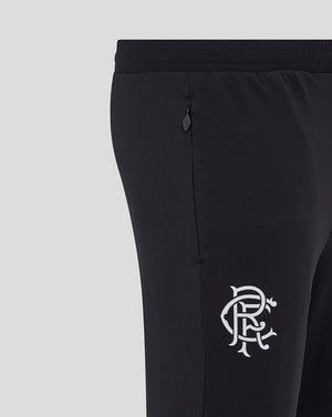 Close-up of black Rangers training knit pants showing waistband and zip pocket with a club crest on the thigh.