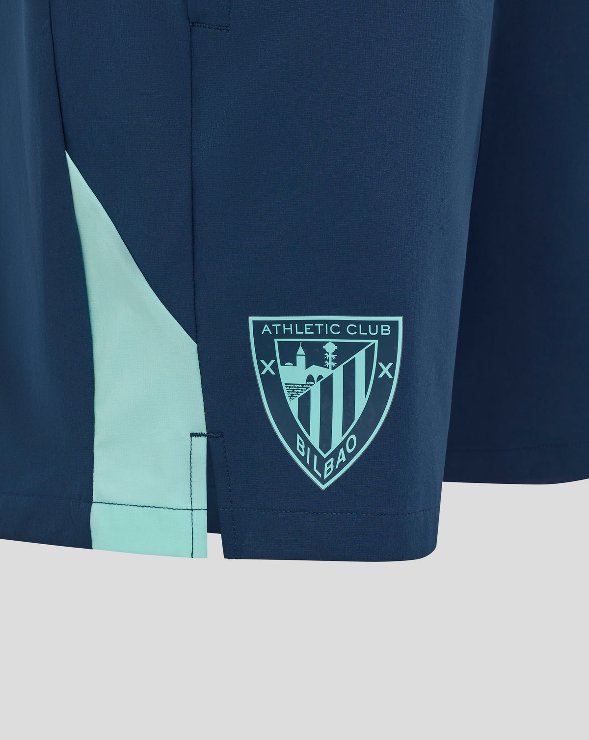 Athletic Club training shorts in dark navy with light teal panel and club crest