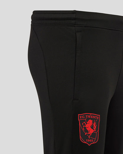 Close up of black FC Twente performance pants with a red crest patch on the leg