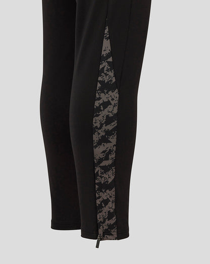 Side view of black FC Twente pants featuring a gray camo panel and zip at the hem
