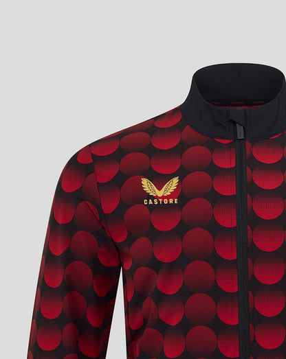 Feyenoord home matchday jacket close up showing red circle pattern on black fabric with gold Castore logo