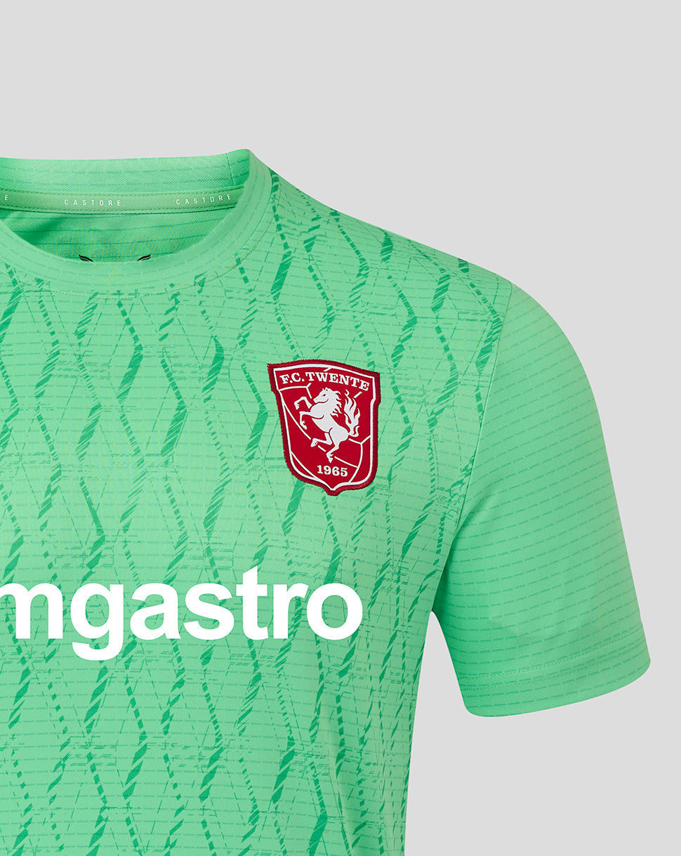 Close up of FC Twente goalkeeper shirt in light green with a geometric print and the club crest on the chest