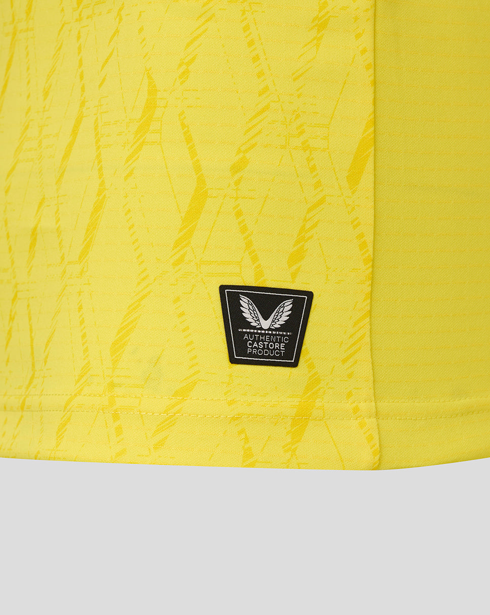 Yellow textured fabric with a black label featuring wings on a white background