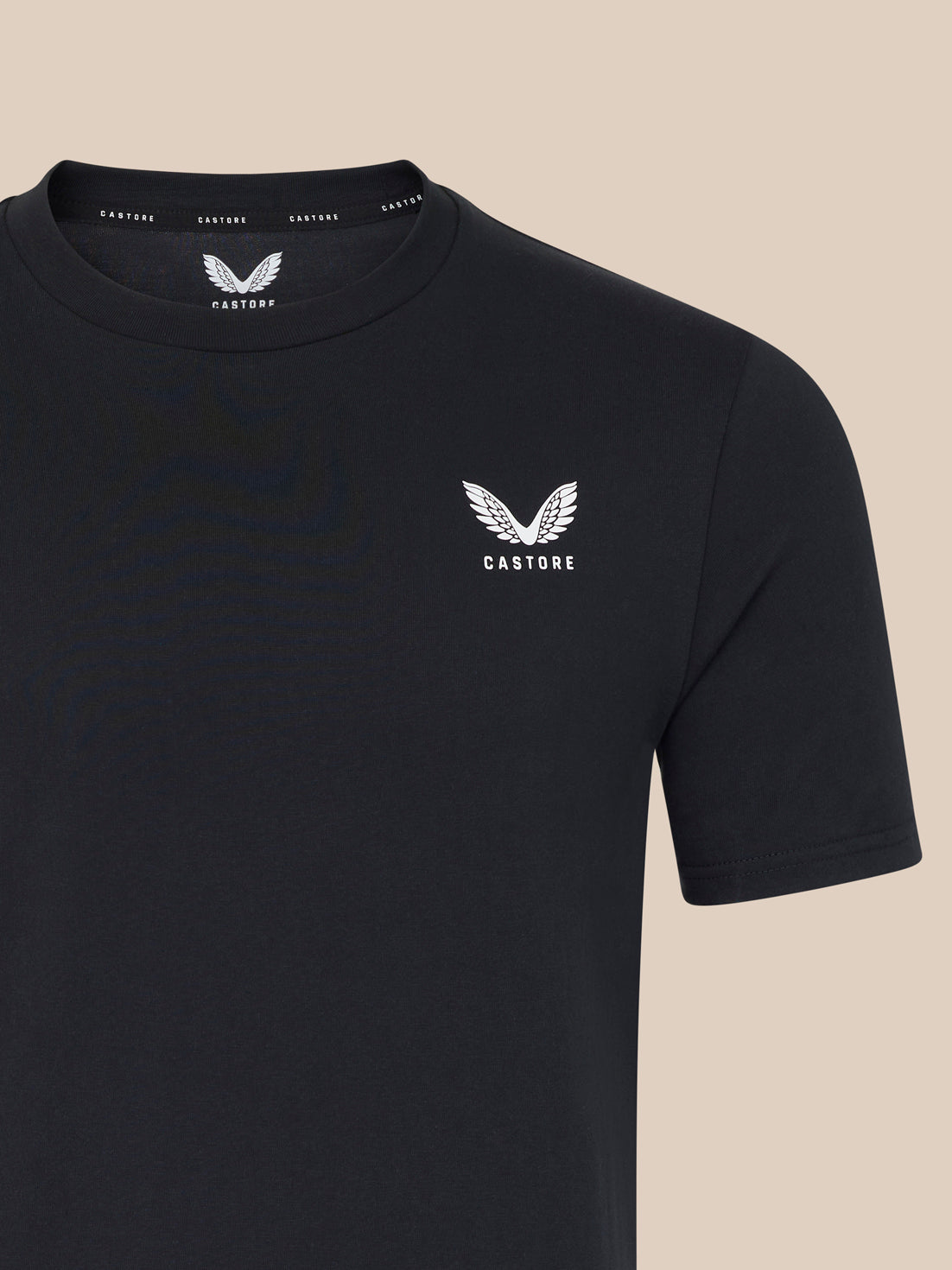 Black t-shirt with a white logo on a beige background