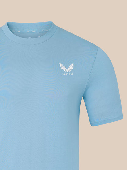Light blue t-shirt with a logo on a beige background