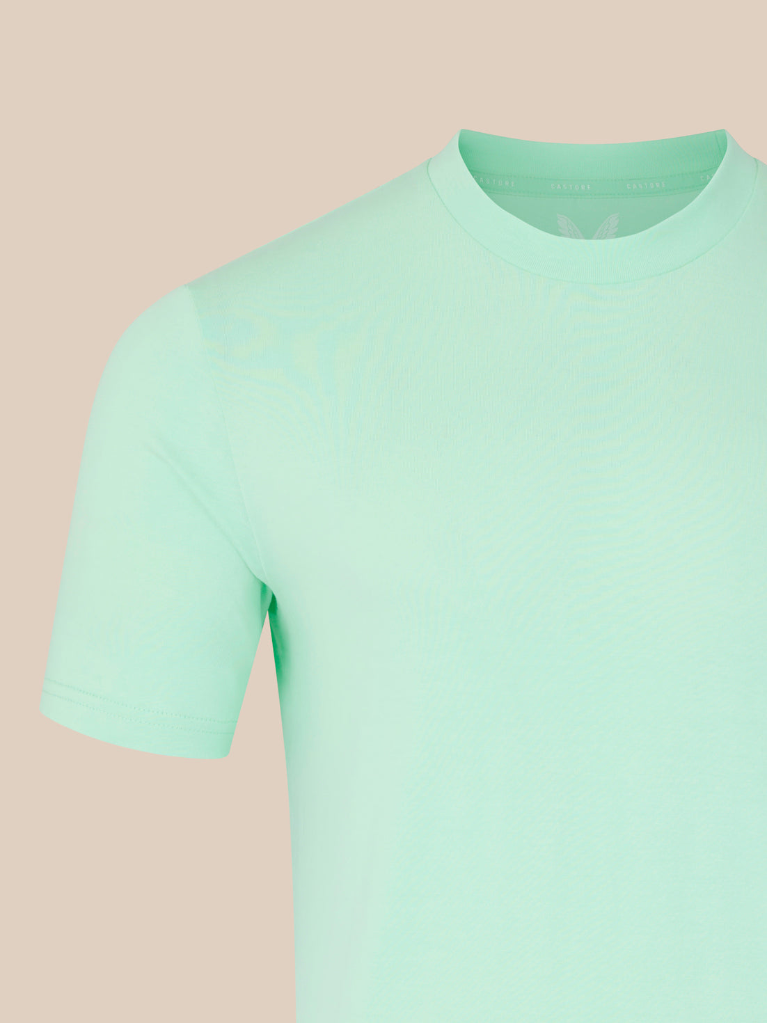 Light green t-shirt on a beige background